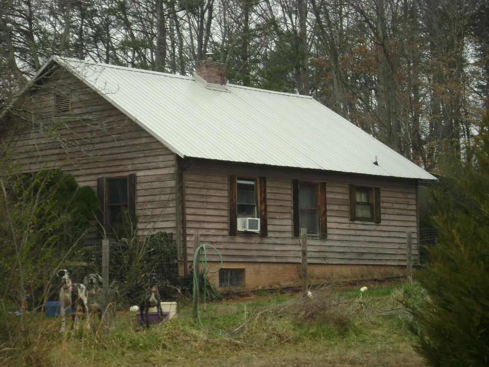 White metal roof on an old wood sided farmhouse, from a Metal Roof Installation job in New Wilmington